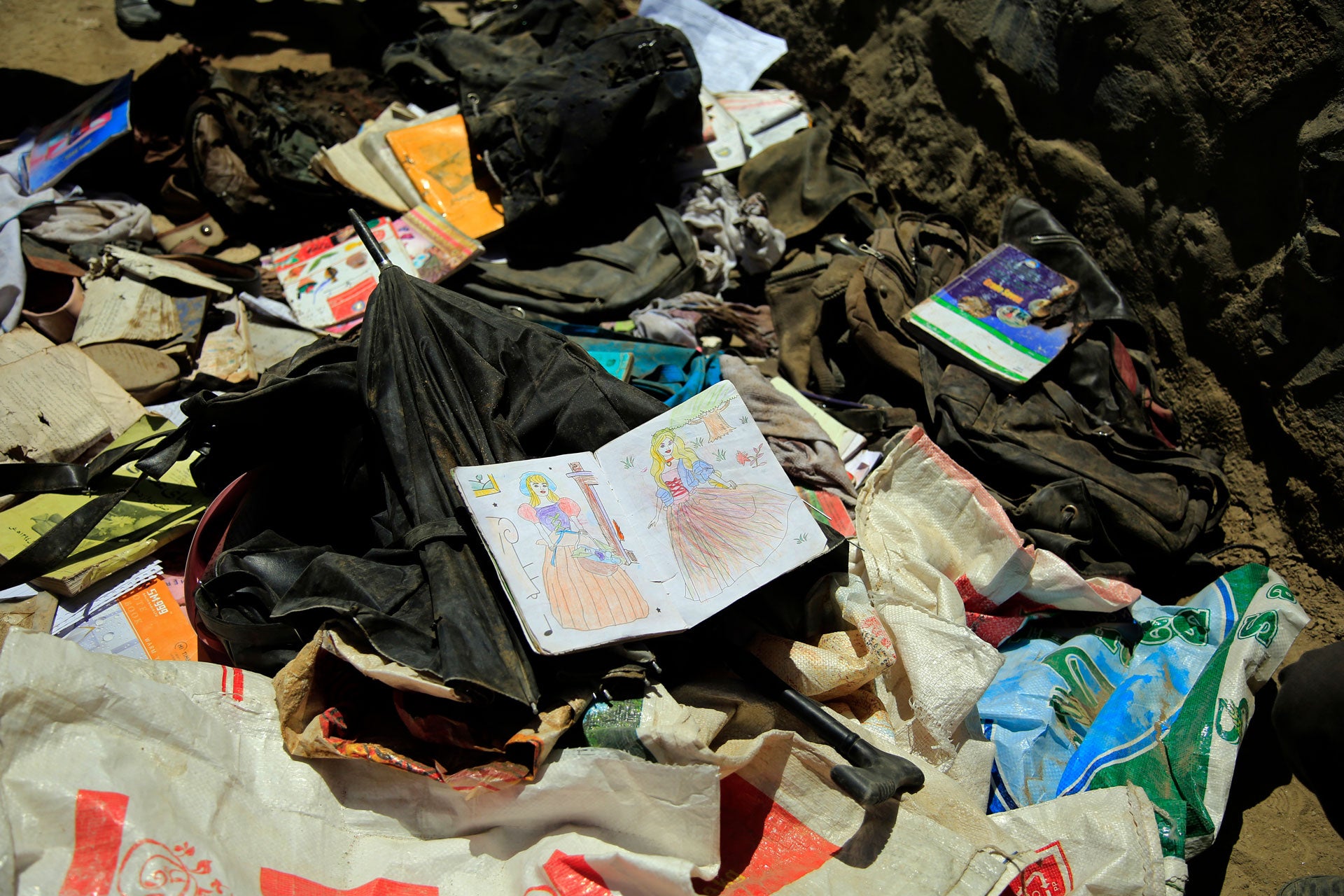 Books, notebooks, and other school supplies are left behind after May 8's deadly bombings near a school in Kabul, Afghanistan, Sunday, May 9, 2021.