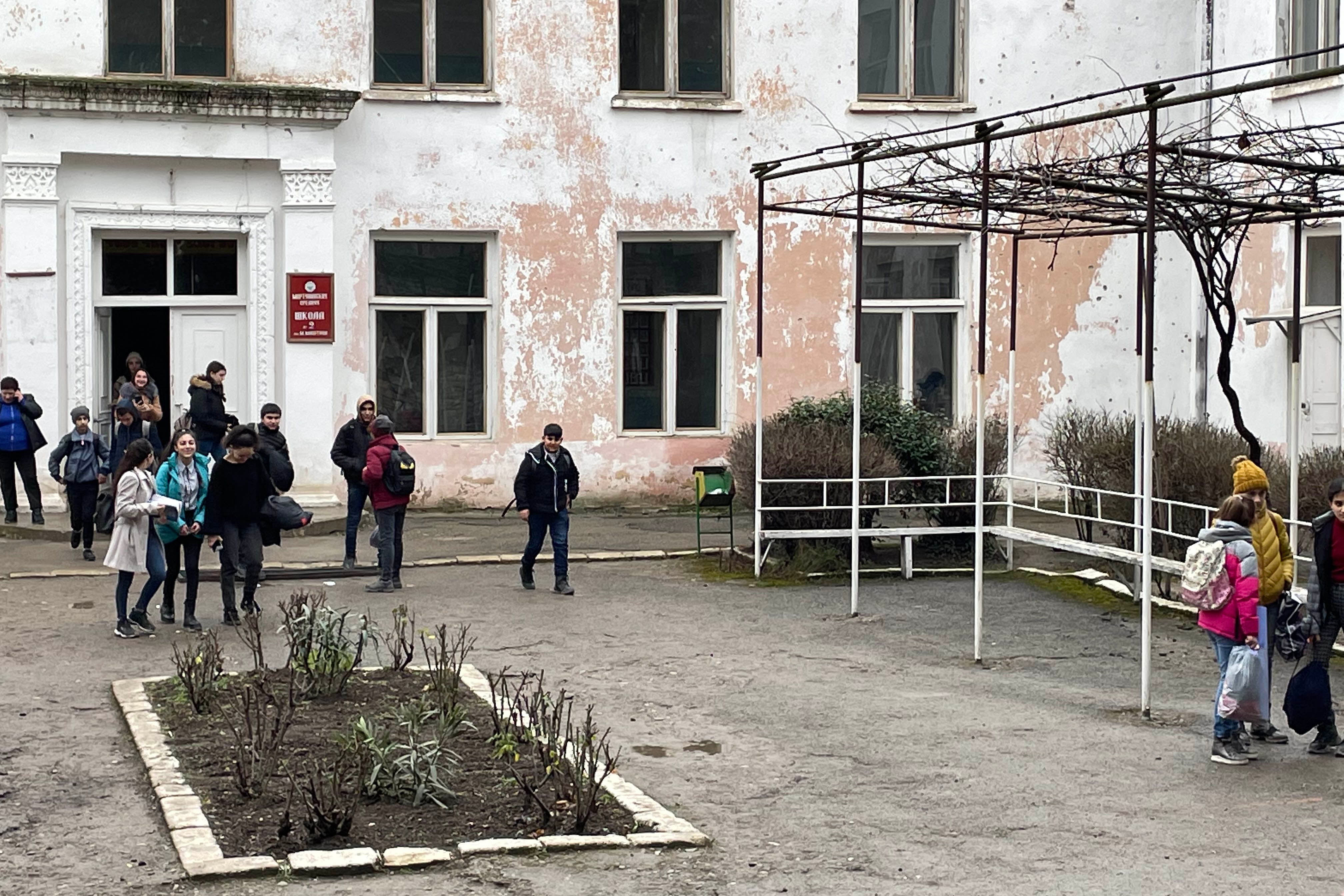School children walking out of a building