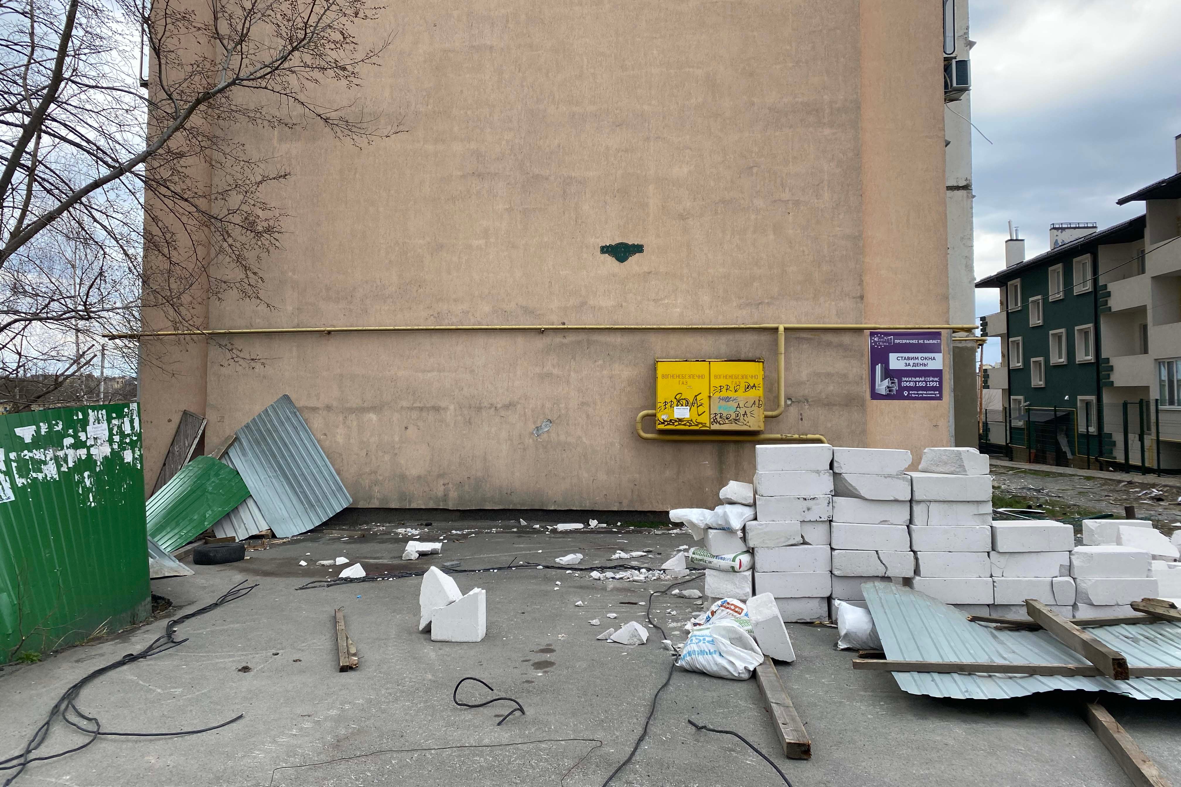 Sur le sol à gauche devant cet immeuble, une flaque de sang subsiste là où des voisins ont trouvé le corps d’Oleh (33 ans) sous des tôles métalliques à Boutcha en Ukraine, en avril 2022.