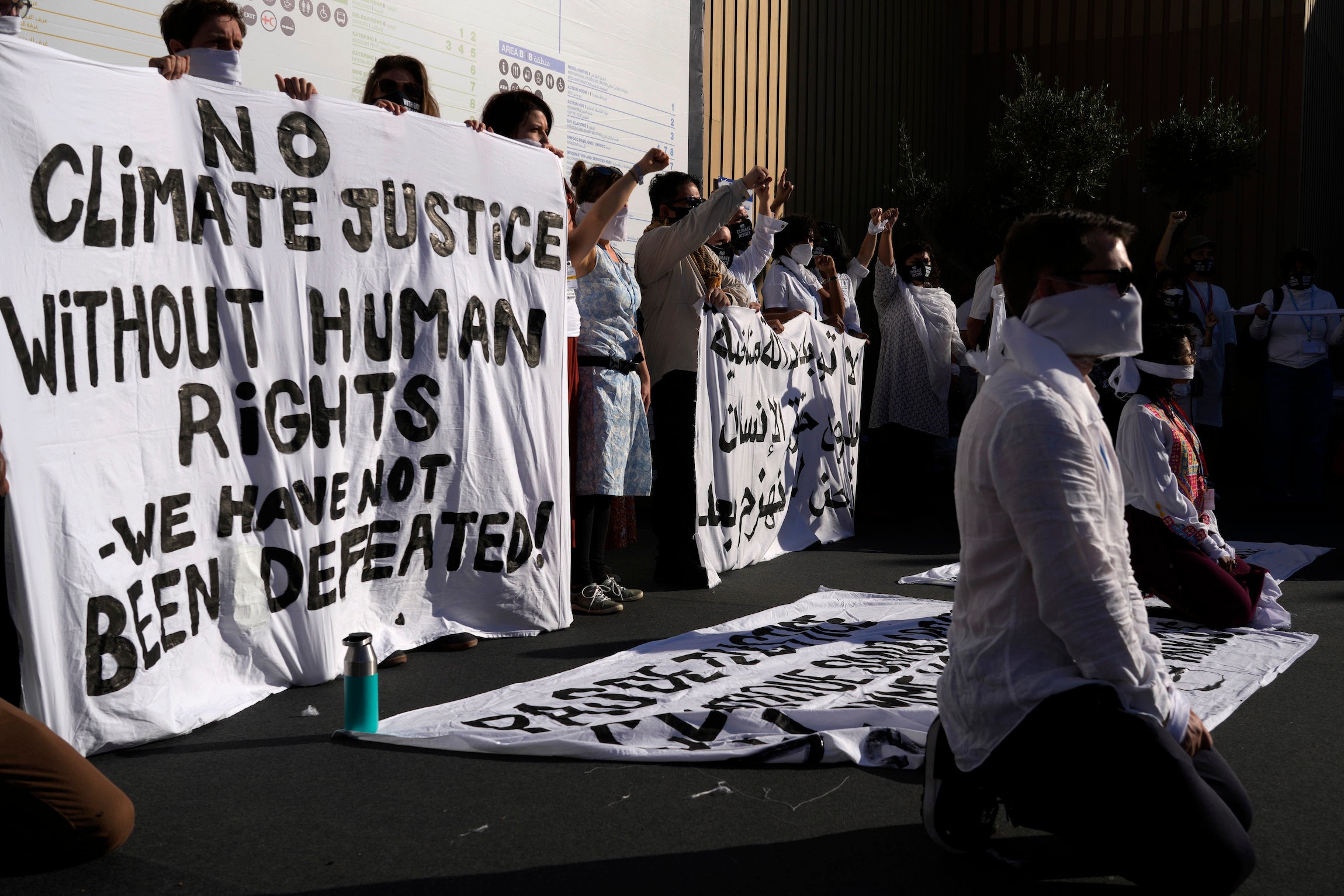 Demonstrators participate in a silent protest at the COP27.