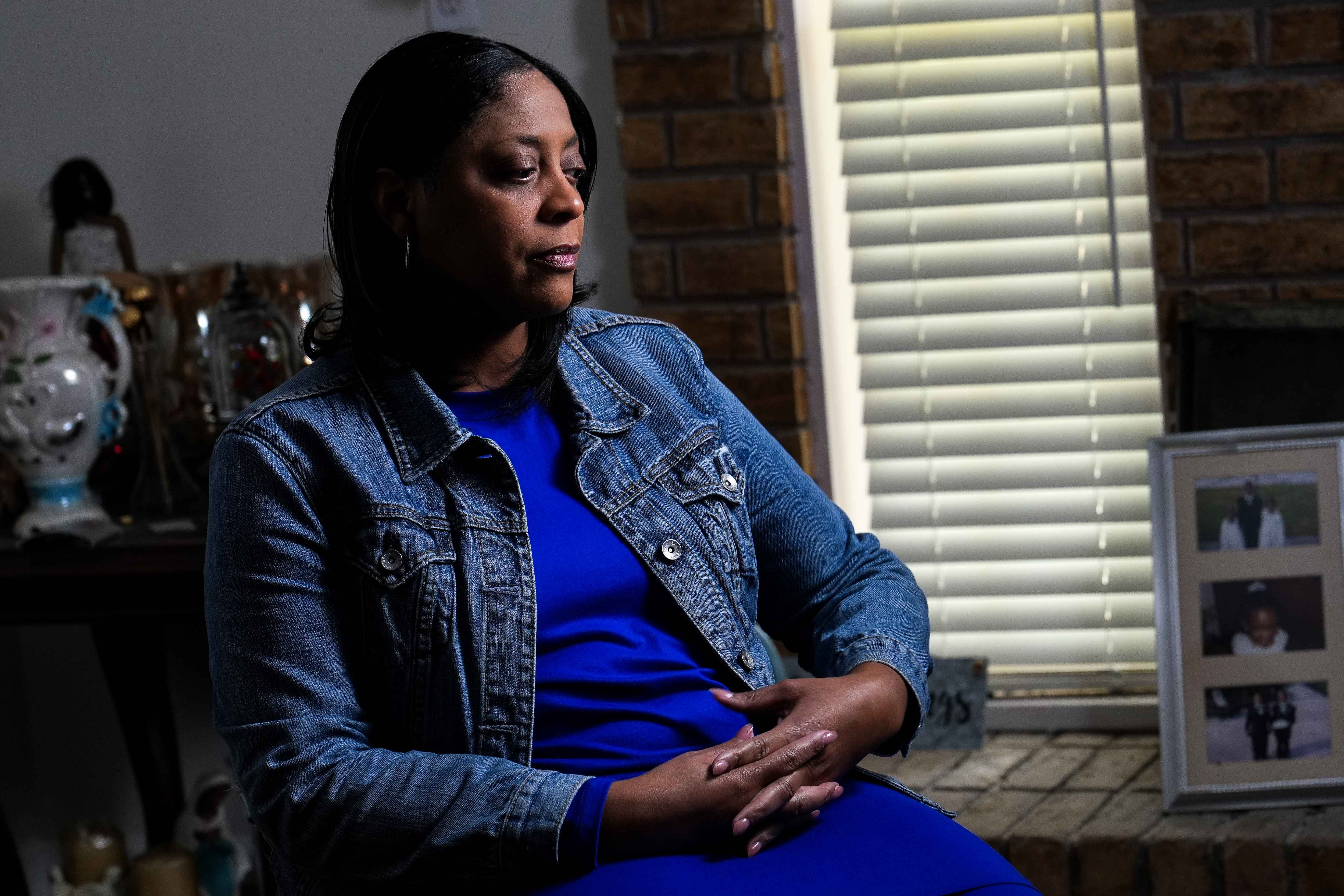 A woman poses for a photo in a chair