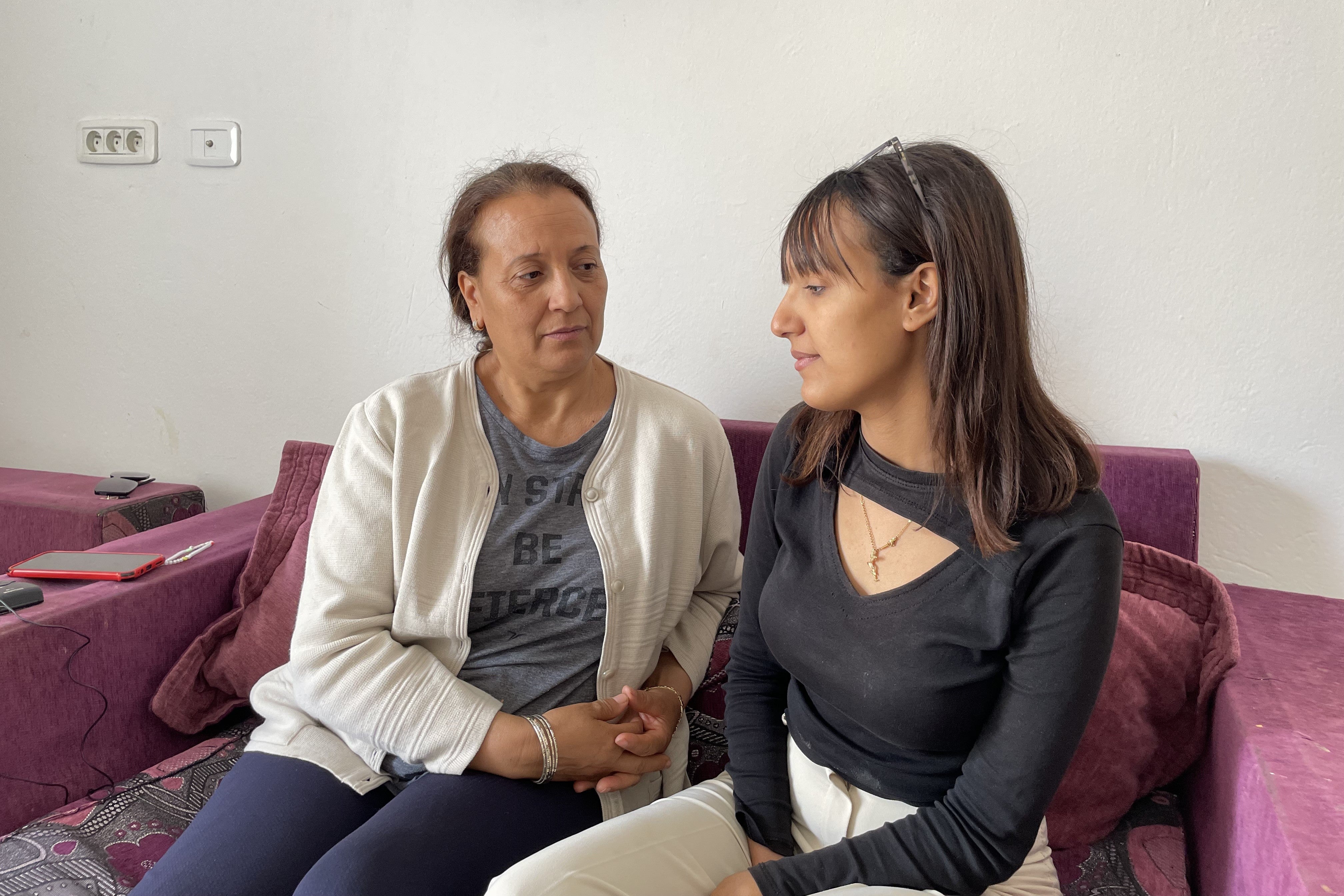 Photo of a mother and daughter sitting on a couch