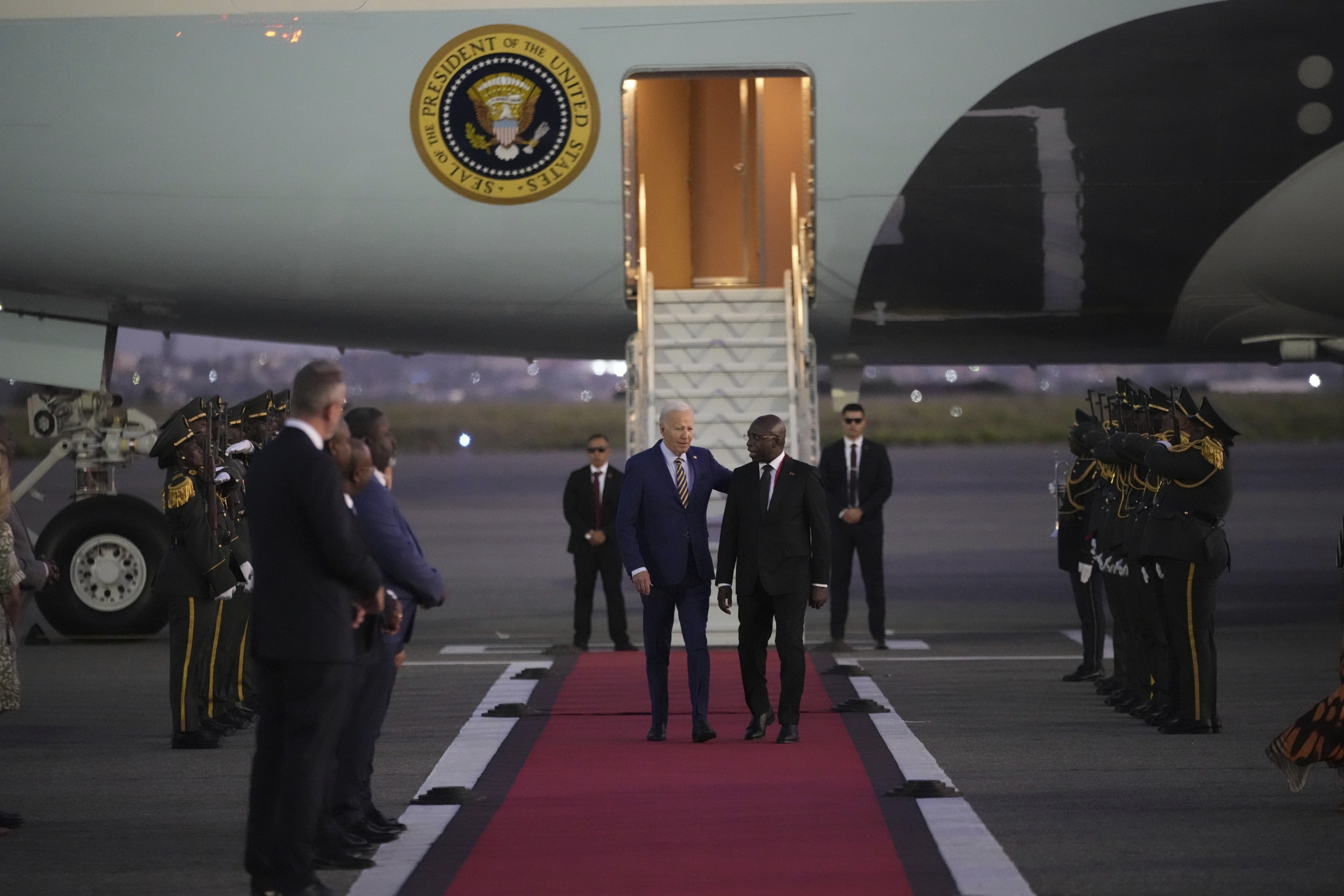 US President Joe Biden is greeted by Angolan Foreign Minister Tete Antonio as he arrives at Quatro de Fevereiro international airport in Luanda, Angola, December 2, 2024.