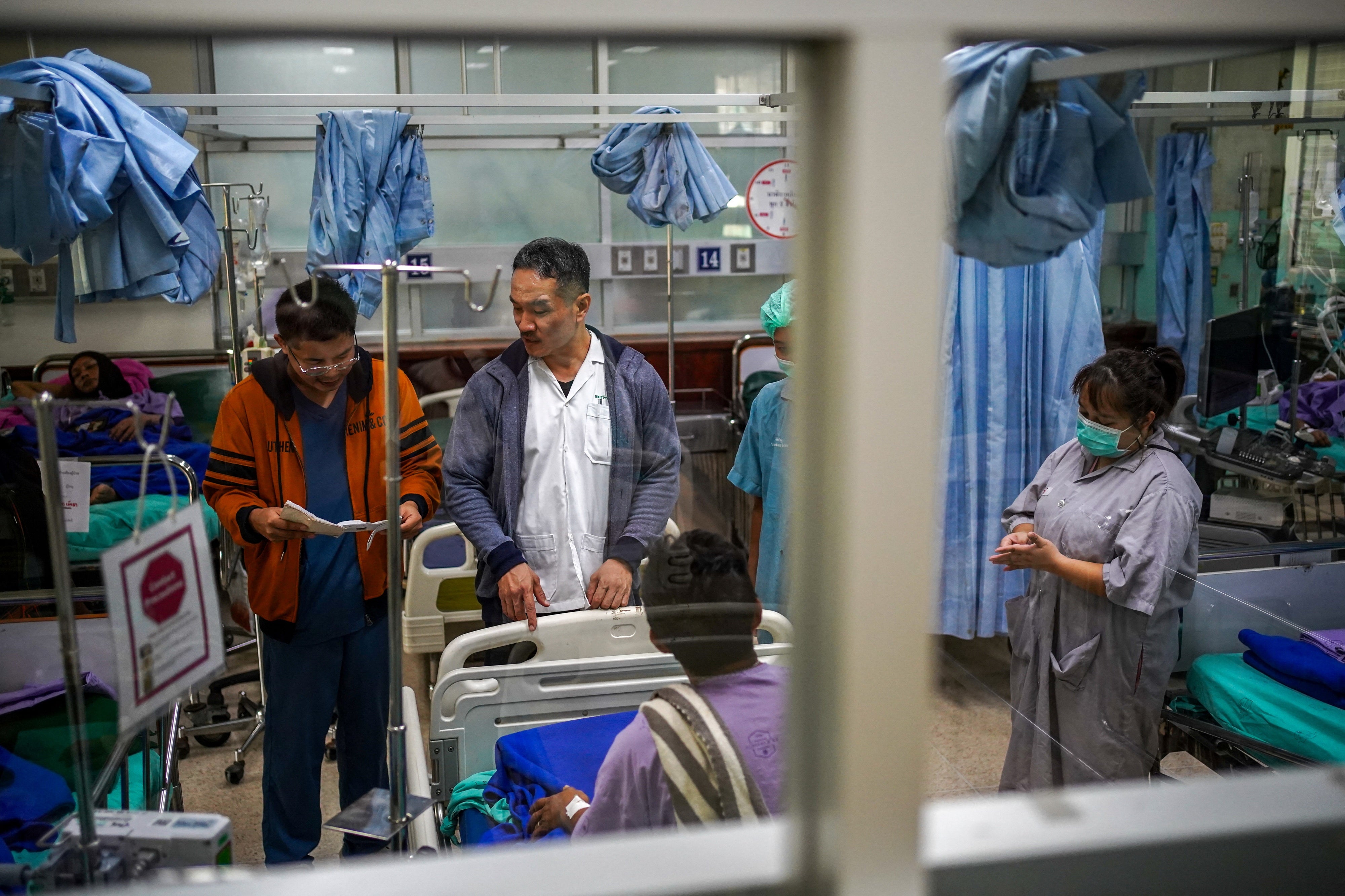 Tawatchai Yingtaweesak, a hospital director, speaks to a refugee from Myanmar who suffers from epilepsy and was transferred to Tha Song Yang Hospital following a halt in US foreign aid that led to the closure of health services inside Mae La refugee camp nearby on the Thai-Myanmar border, at Tha Song Yang district, Tak Province, February 4, 2025. 