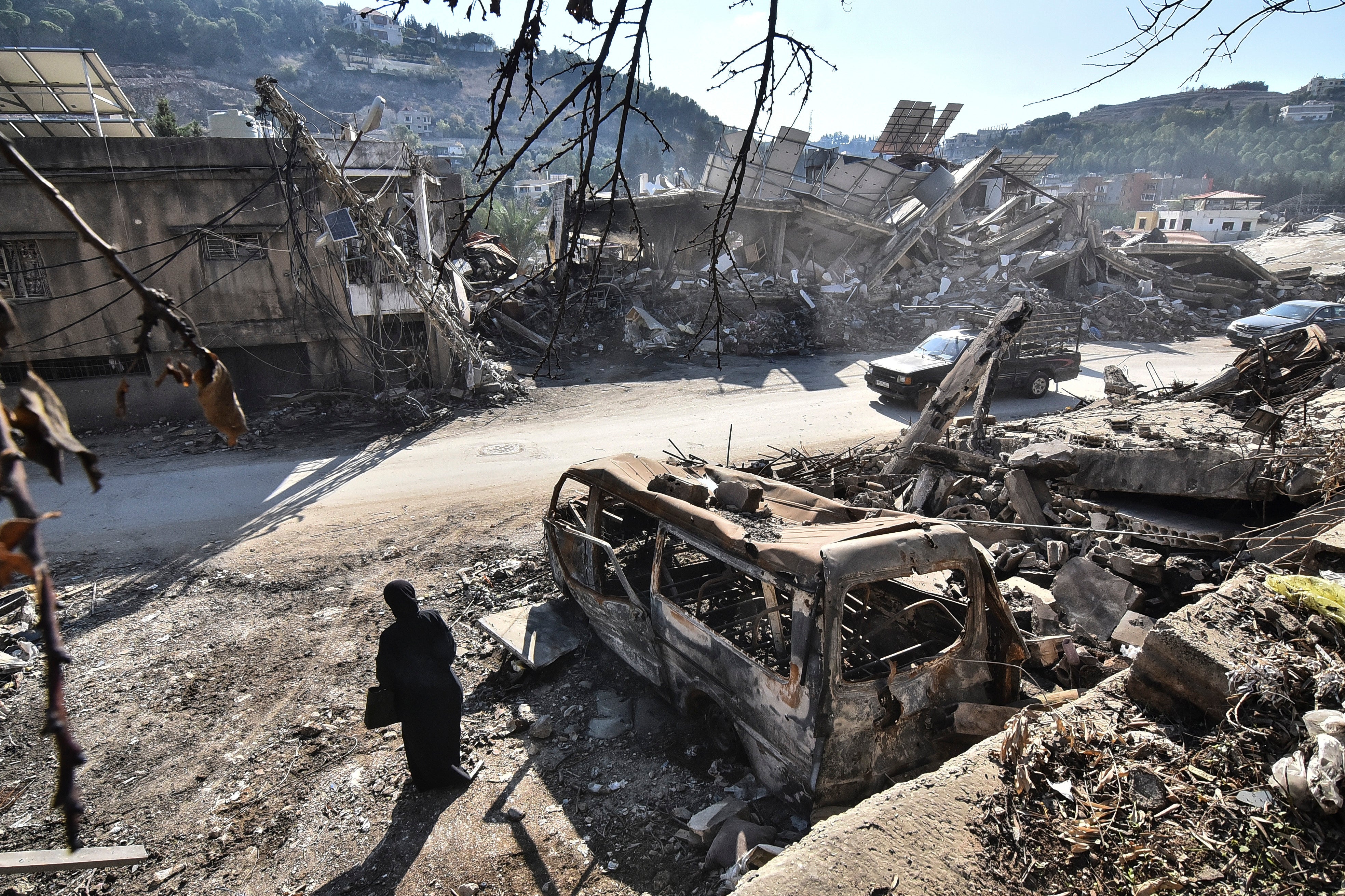 A returning resident to Nabatieh, in southern Lebanon, stands before the wreckage in the city on November 30, 2024, days after the start of a ceasefire between Israel and Hezbollah. 
