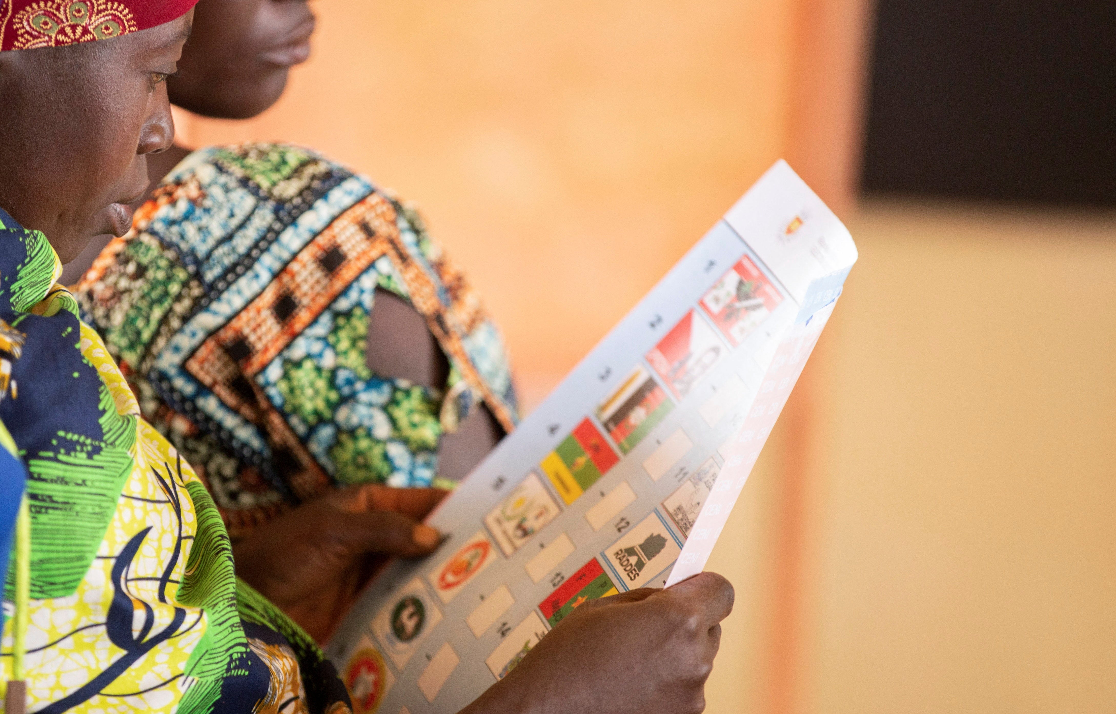 A woman looks at a ballot paper in Giheta Commune of Gitega Province in Burundi