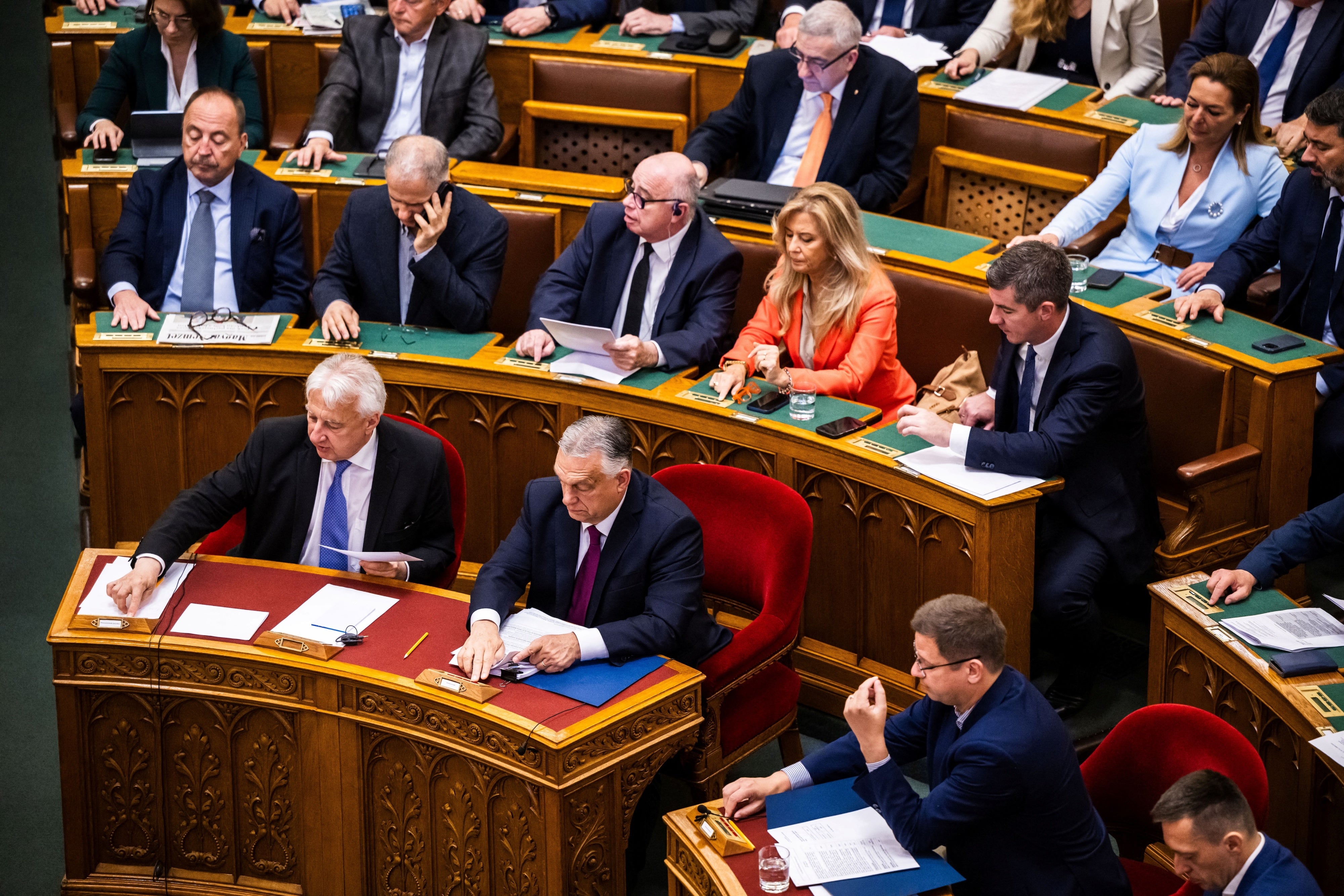 Hungarian Prime Minister Viktor Orban (bottom - C) and Deputy Prime Minister Zsolt Semjen (bottom L) attend the vote to start the withdrawal process from the International Criminal Court (ICC) in Budapest, Hungary, May 20, 2025.