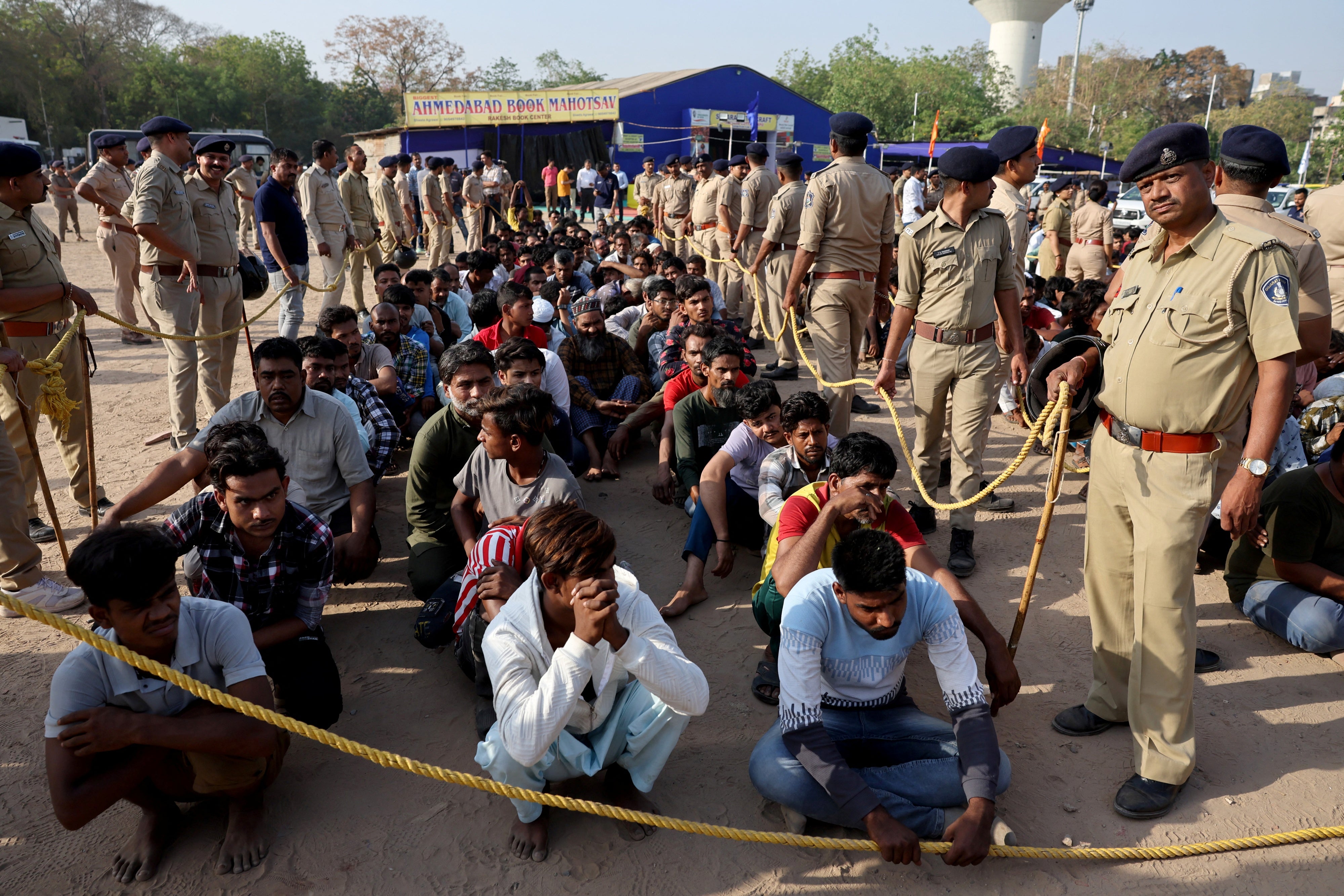 Police officers detain alleged undocumented Bangladeshi nationals after they were arrested during raids in Ahmedabad, India, April 26, 2025.