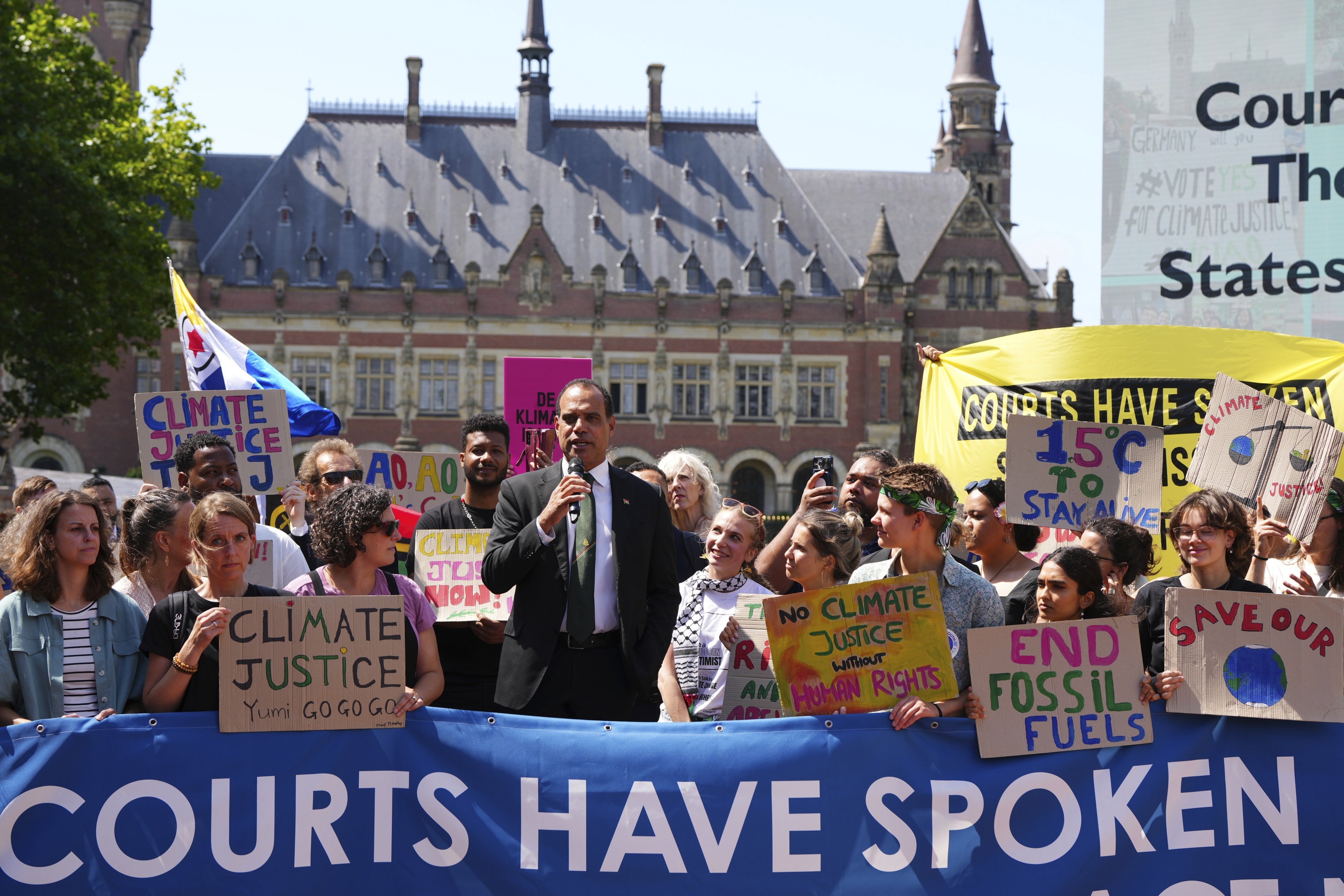 Ralph Regenvanu, Vanuatu's minister for climate change, speaks surrounded by demonstrators at the International Court of Justice ahead of an advisory opinion on what legal obligations nations have to address climate change in The Hague, Netherlands, July 23, 2025.
