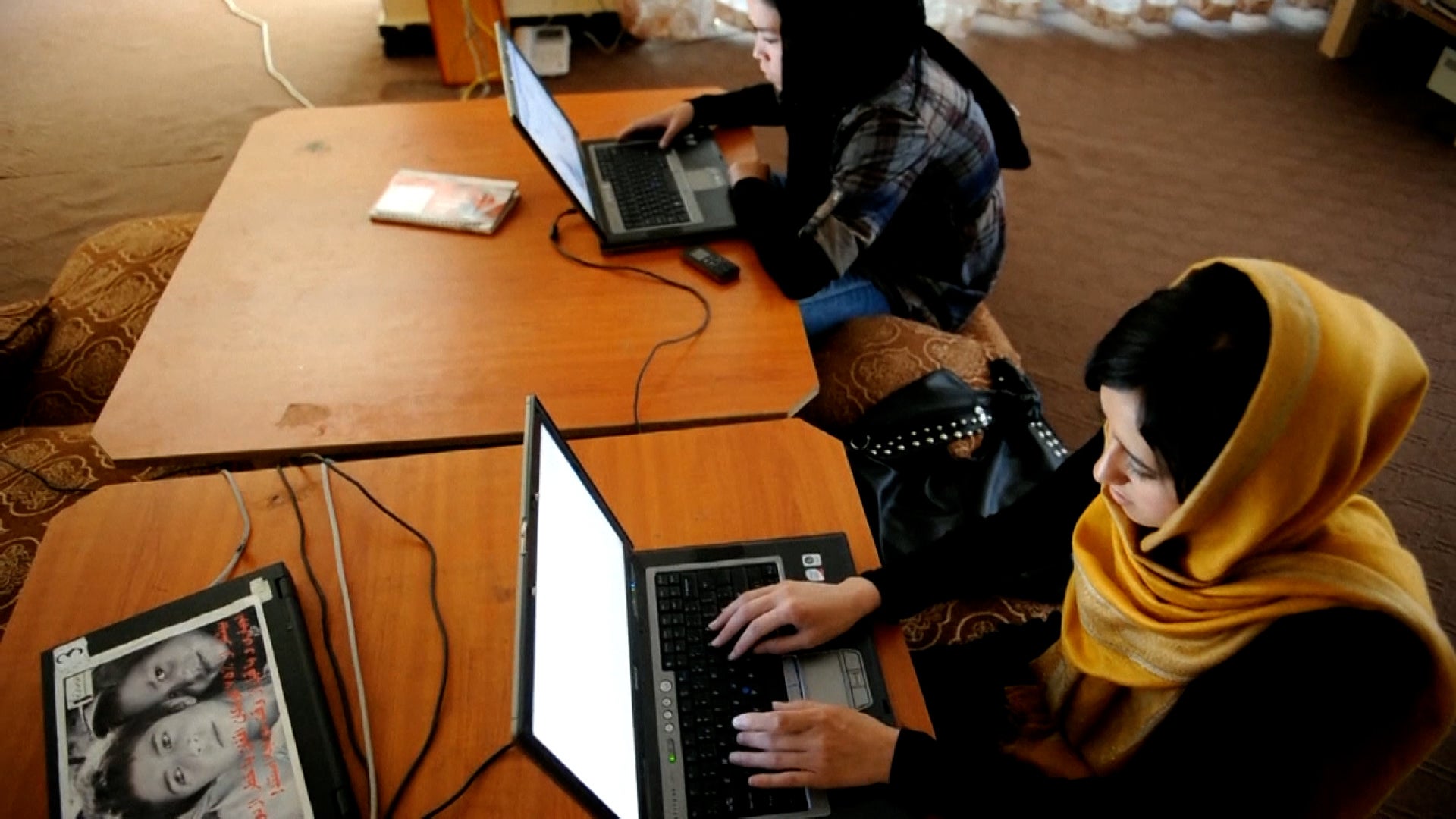 In July 2012, Afghan women and girls visit an internet cafe called "Young Women for Change" in Kabul, Afghanistan. 