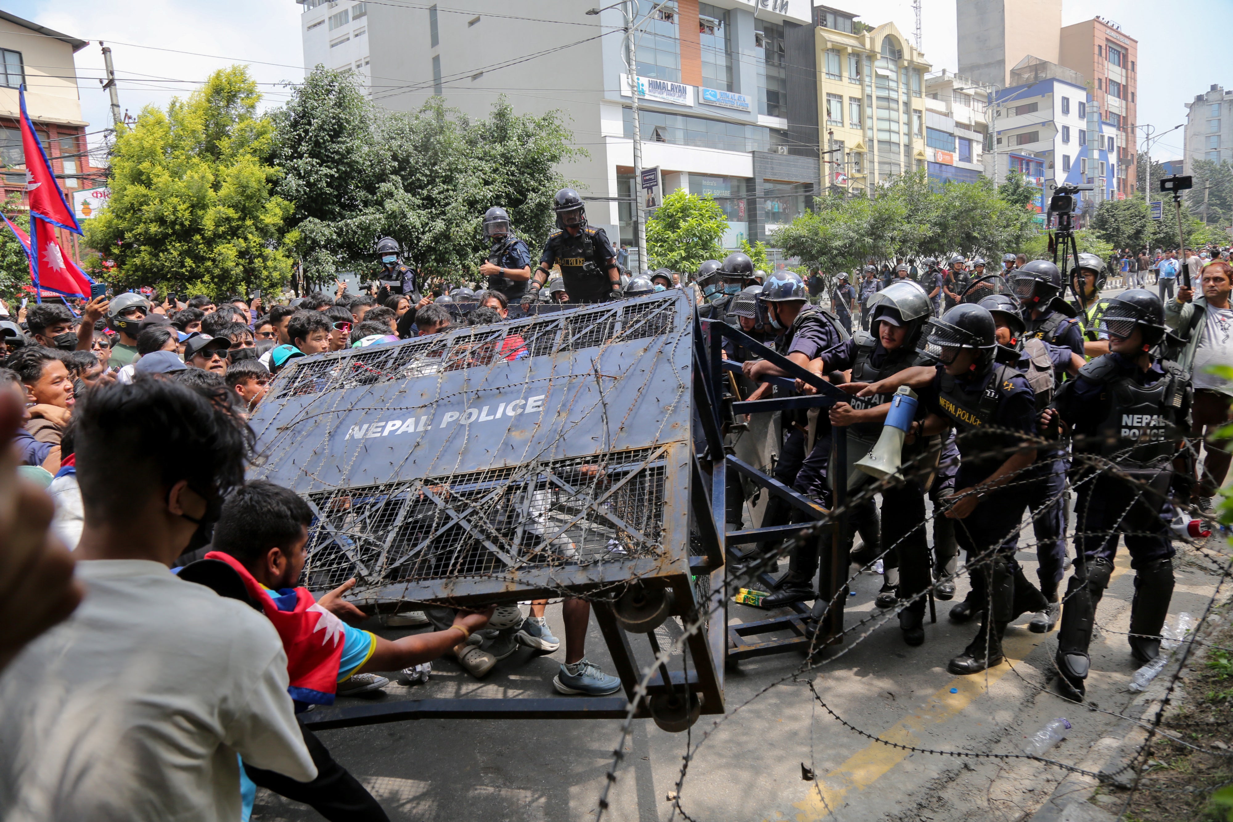 Protesters topple a police barricade blocking the route to parliament in Kathmandu, Nepal, September 8, 2025.