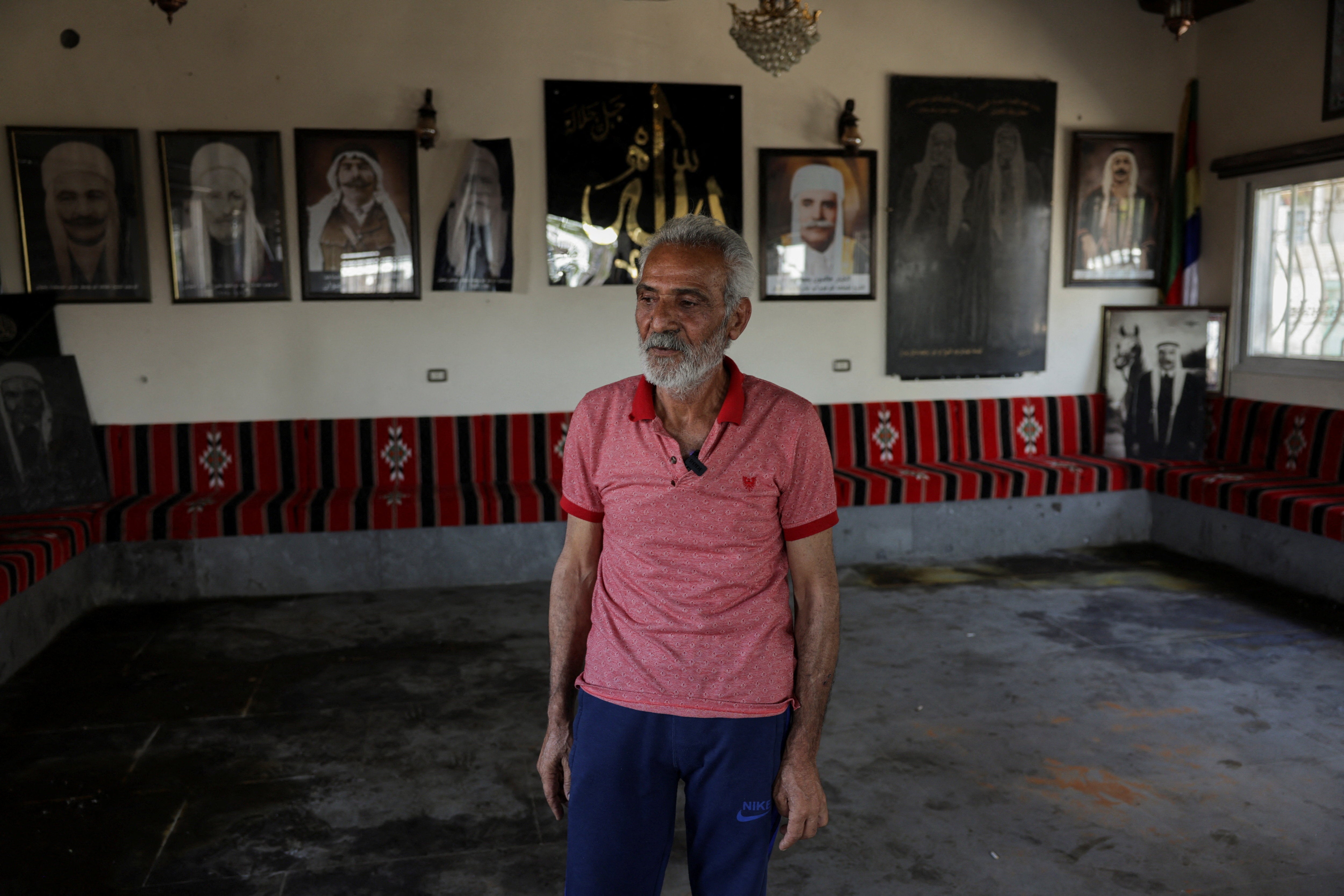 Hatem Radwan stands near bloodstains inside the Al-Radwan guest house, after a deadly shooting, in the predominantly Druze city of Sweida, Syria, July 25, 2025. 