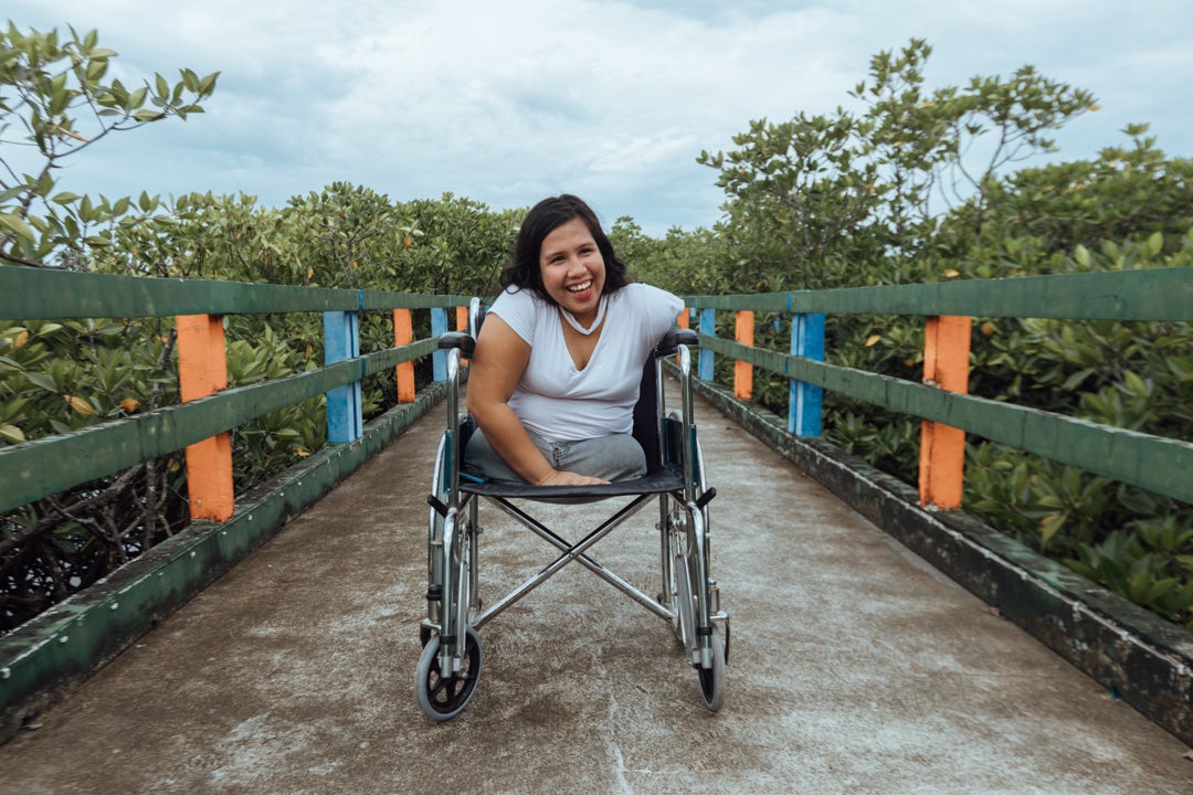 Johanna in her wheelchair on a boardwalk in the mangrove forest in Del Carmen, Siargao, Philippines, 2025.