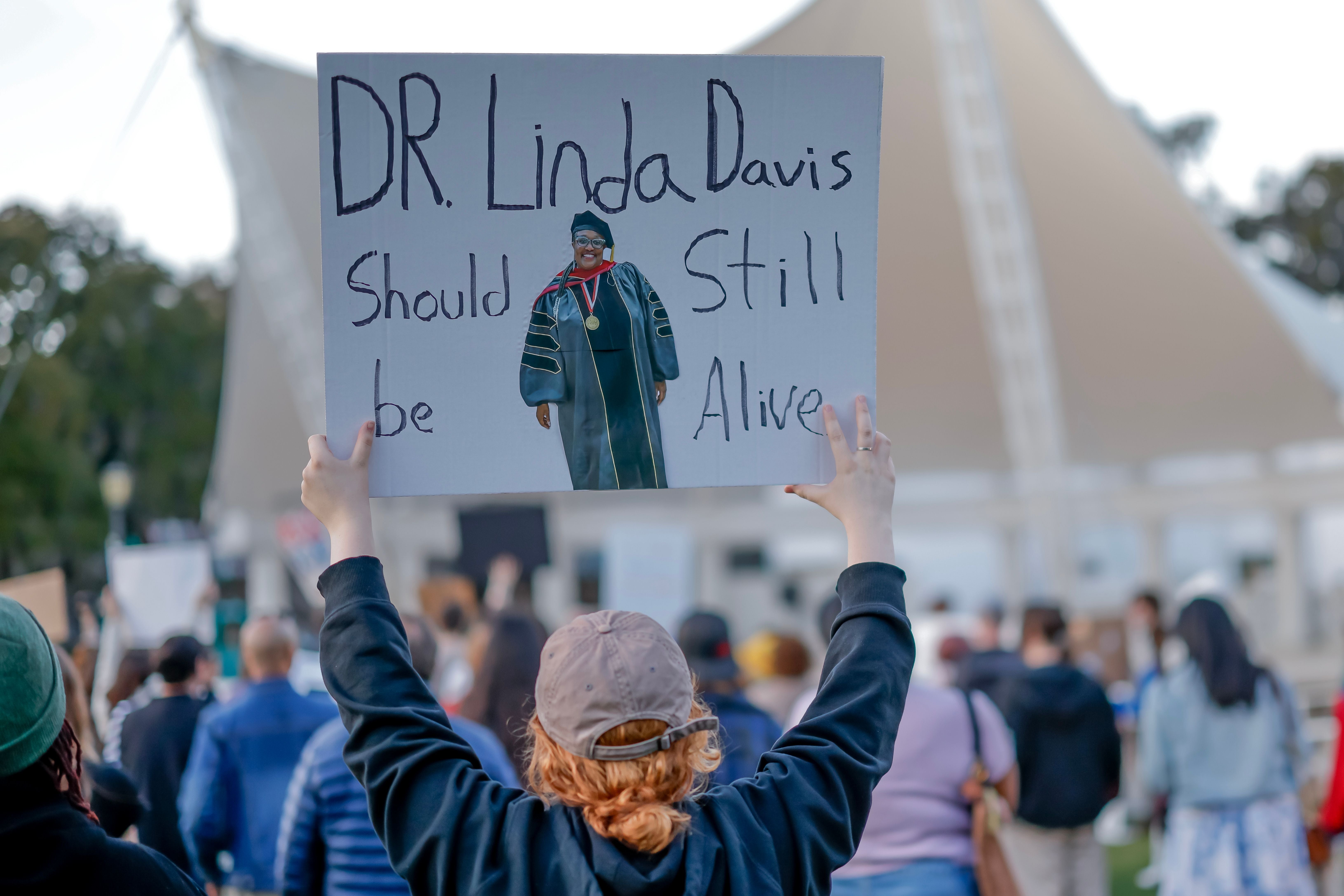 People protest at Forsyth Park after the death of teacher Linda Davis, who was killed in a vehicle collision with a man fleeing from US Immigration and Customs Enforcement (ICE) agents in Savannah, Georgia, US, February 17, 2026. 
