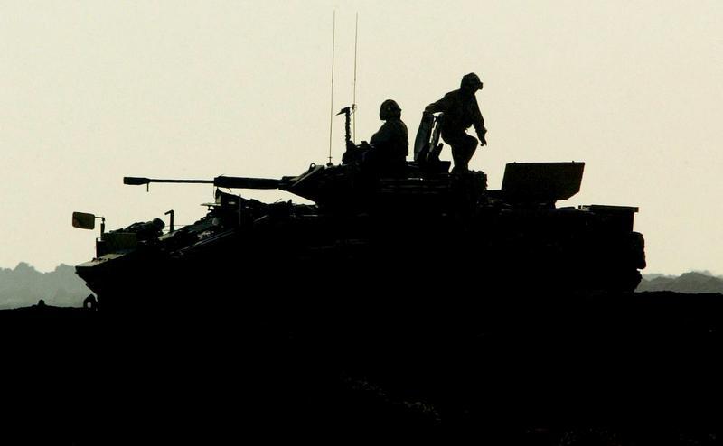 British soldiers prepare their armored vehile to patrol Ahmed al-Ahmedi, 30 miles south west of Baghdad, November 5, 2004.