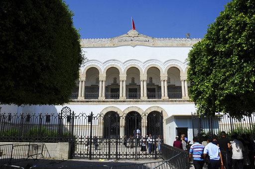 People enter the Tunis hall of justice, Friday May, 26, 2017.