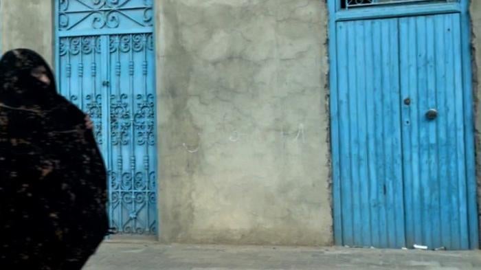 A woman walking on the street in Zarziss, Tunisia.