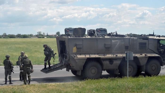 Russian servicemen on the roadside in Kherson region, Ukraine. © 2022 Olga Maltseva/AFP/Getty Images 