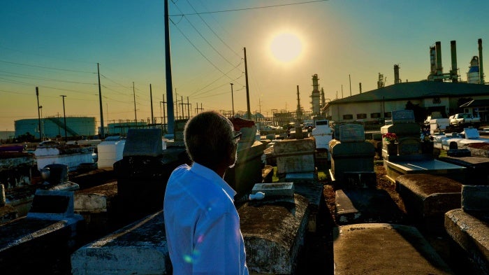 A man stands in a cemetery