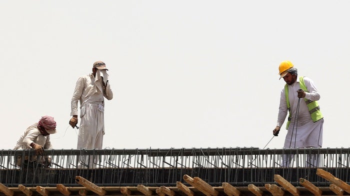 Migrant workers at a construction site amid scorching heat