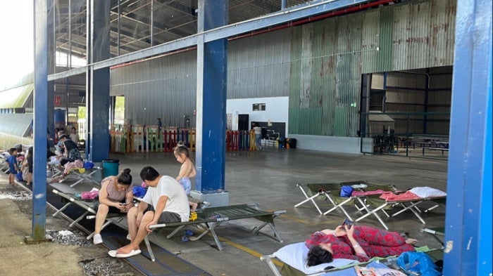 The interior of Costa Rica’s migration reception center in Puntarenas, showing the play area for children behind a row of cots.