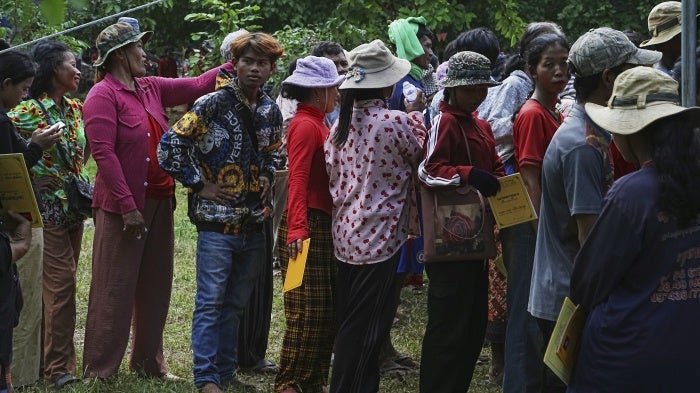 Cambodians who fled Thai-Cambodian border clashes line up to receive assistance in Oddar Meanchey province, Cambodia, July 25, 2025. 