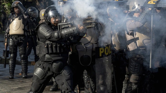 An Indonesian police officer fires tear gas during a demonstration in Jakarta, Indonesia, August 28, 2025. 