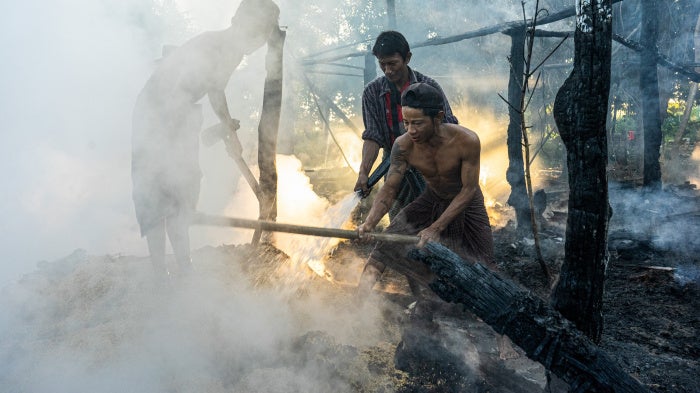 Villagers extinguish a fire that engulfed a house after a Myanmar military airstrike, Tabayin, Myanmar, November 13, 2025.