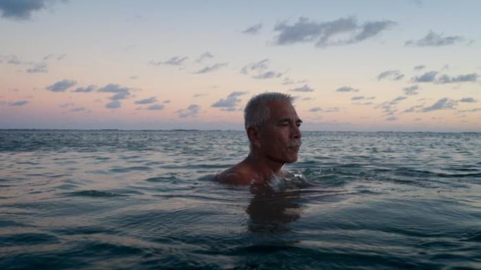 Anote Tong, then president of Kiribati, swims in the lagoon near his home.