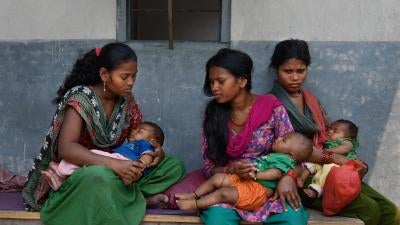Women and girls wait with their children outside a doctor’s office in Chitwan, Nepal. 