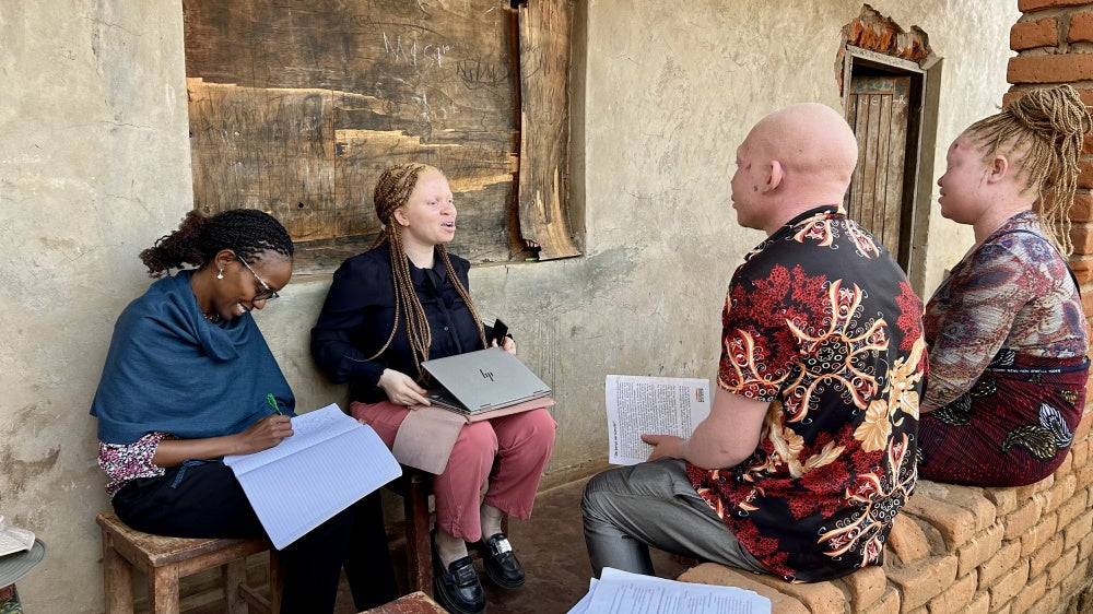 Human Rights Watch Director of the Disability Rights Division, Elizabeth Kamundia (left), and Marco Bristo Fellow for Courageous Leadership in Disability Rights, Hilda Macheso (center), interview people in Malawi, October 2025. 