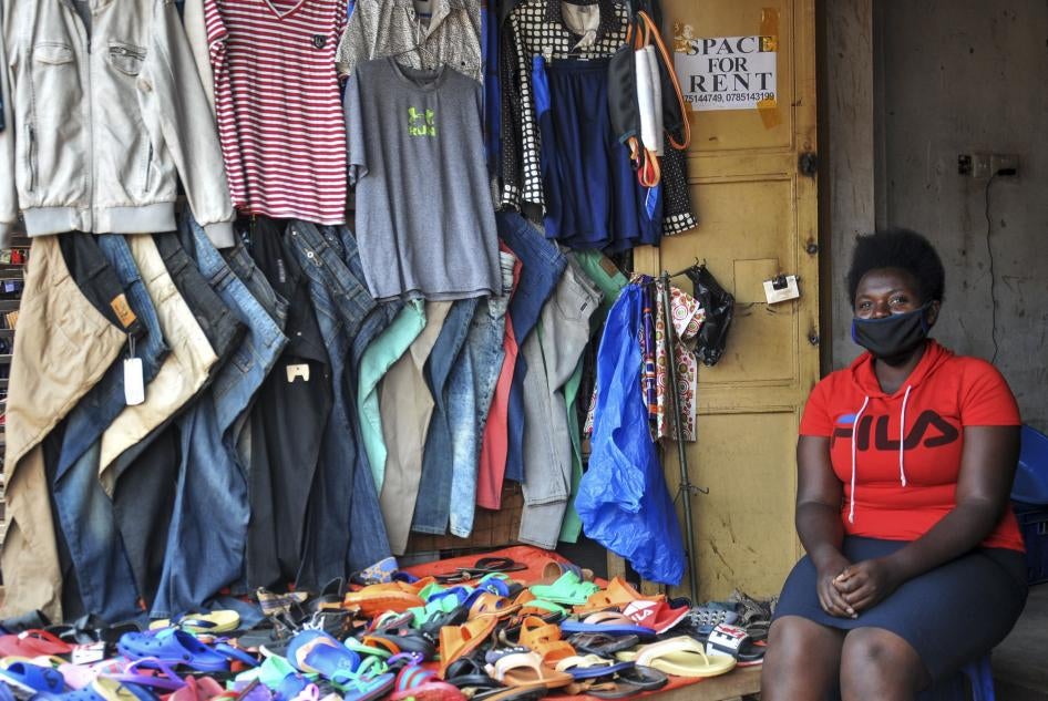 Grace Twisimire, 25, sits in her shop selling clothes and plastic shoes in Kampala, Uganda, June 20, 2020.