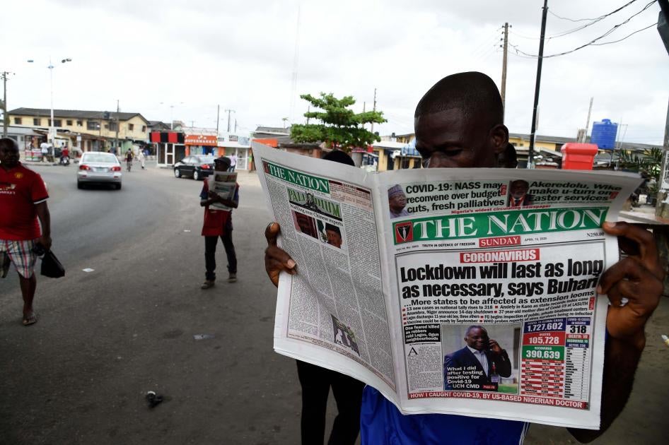 A man reading the newspaper "The Nation"