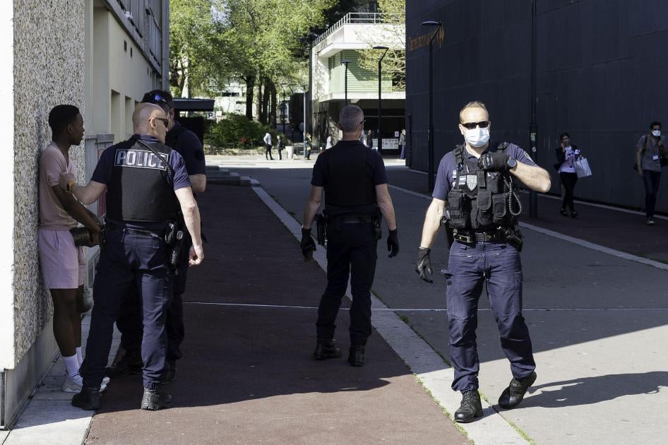 Police agents check identity documents of passerby during the lockdown in Rennes, France. April 11, 2020. 