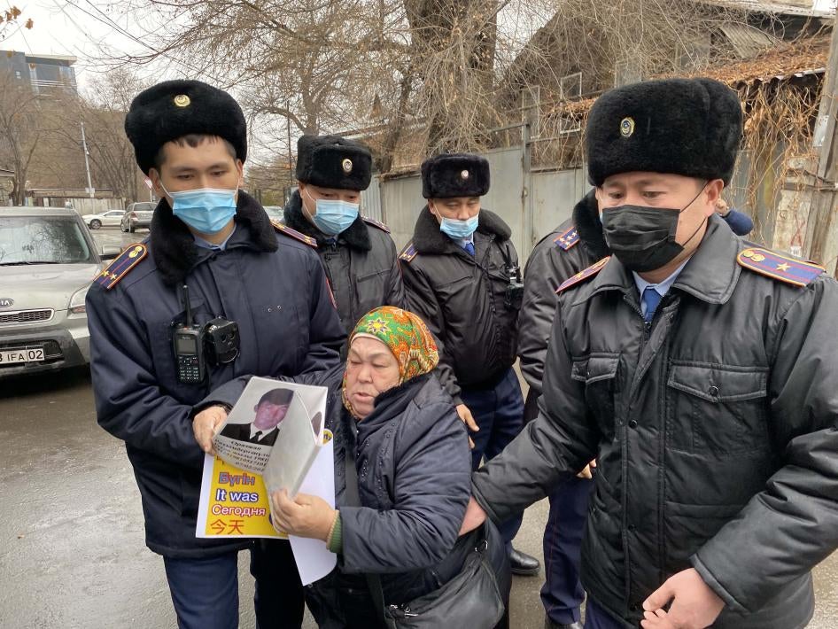 Police detain Khalida Akytkhan outside the Chinese Consulate in Almaty, Kazakhstan, where relatives of people detained or disappeared in Xinjiang, China have been protesting for over 300 days.