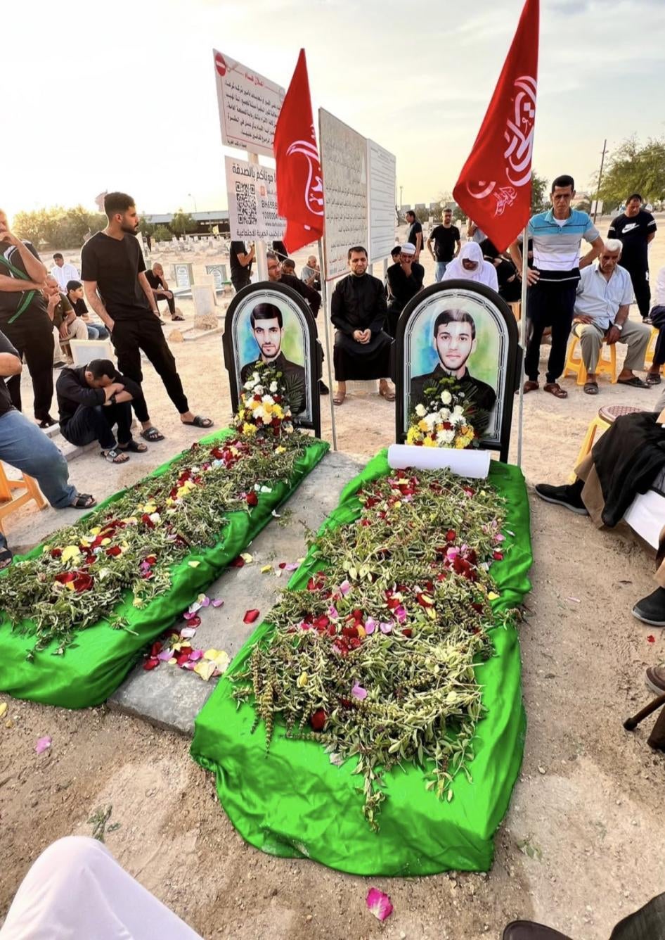 People gather around the symbolic graves of Jaafar Sultan (left) and Sadeq Thamer