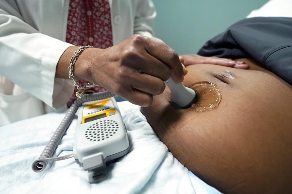 A doctor examines a pregnant woman to measure the heartbeat of the fetus, Jackson, Mississippi, US, December 17, 2021. 