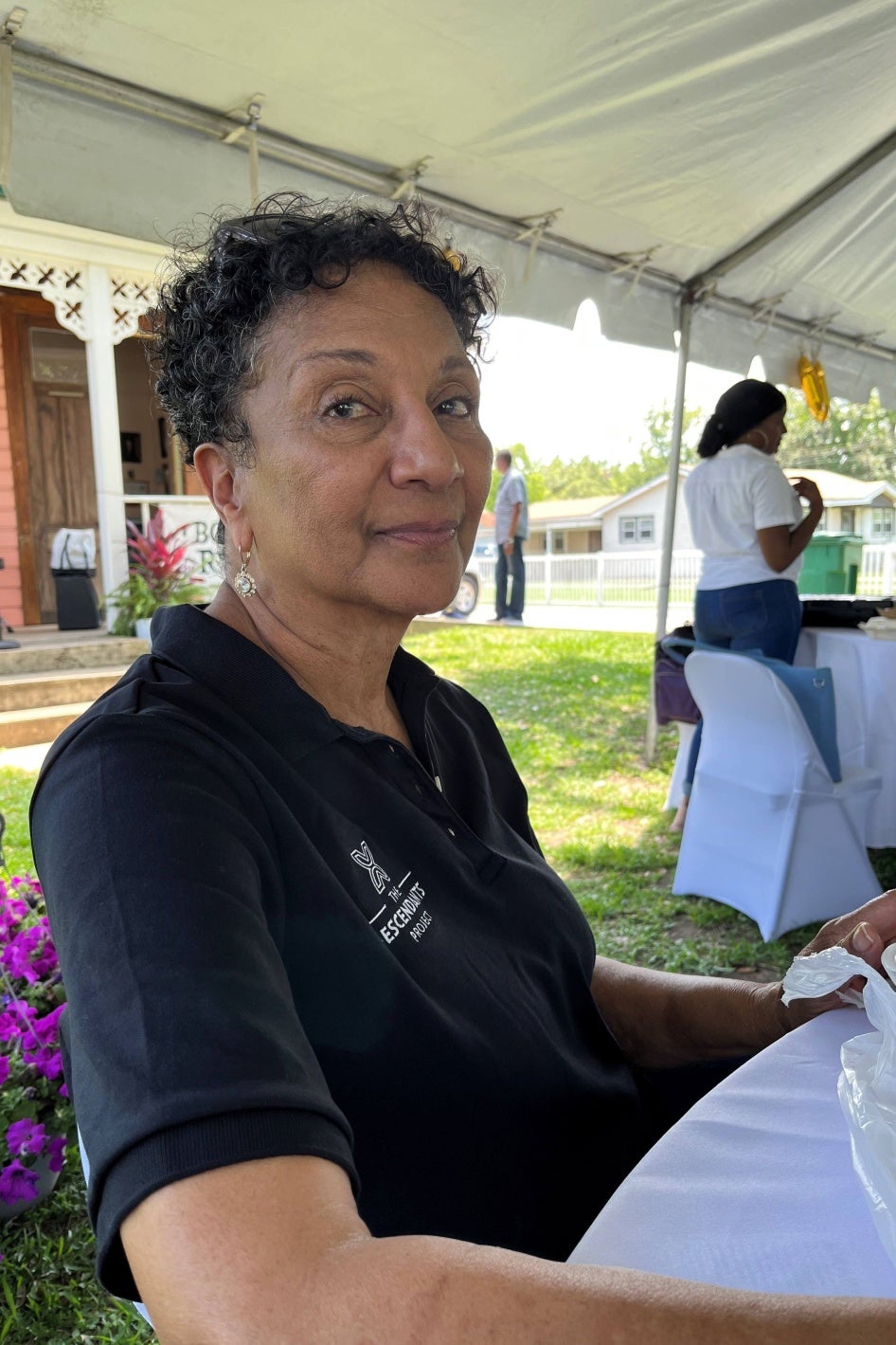 A woman poses for a photo outside