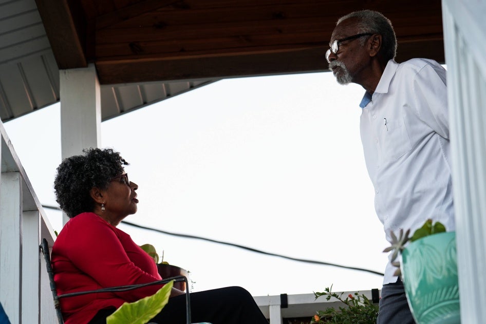 A father and daughter outside their home