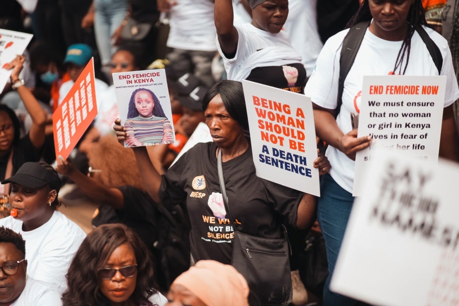 A woman is seen holding protest signs during the #EndFemicideKE and #TotalShutdownKE march in Nairobi, Kenya, January 27, 2024.