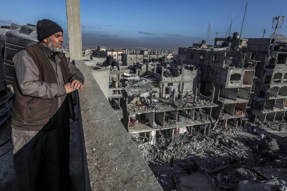 A Palestinian man looks at the destruction of al-Farouq Mosque and other nearby houses caused by Israeli attacks