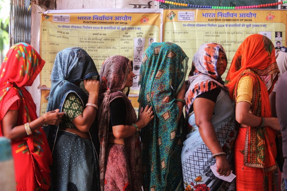 Voters wait at a polling station