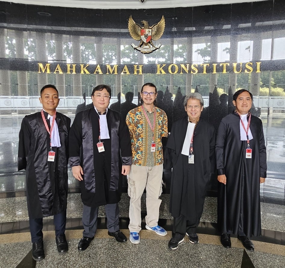 Daniel Tangkilisan (C), the environmentalist who filed the petition, and Todung Mulya Lubis (L-C) and other lawyers from the LSM law firm, at Indonesia’s Constitutional Court in Jakarta, April 29, 2025.