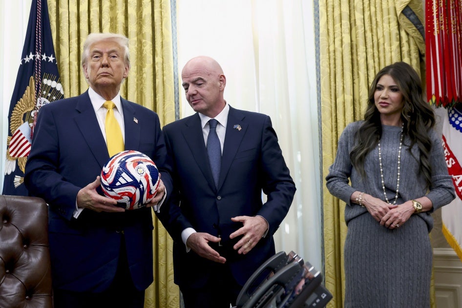 US President Donald Trump (L), with FIFA President Gianni Infantino (C) and Homeland Security Secretary Kristi Noem watch in the Oval Office of the White House in Washington, DC, March 7, 2025.