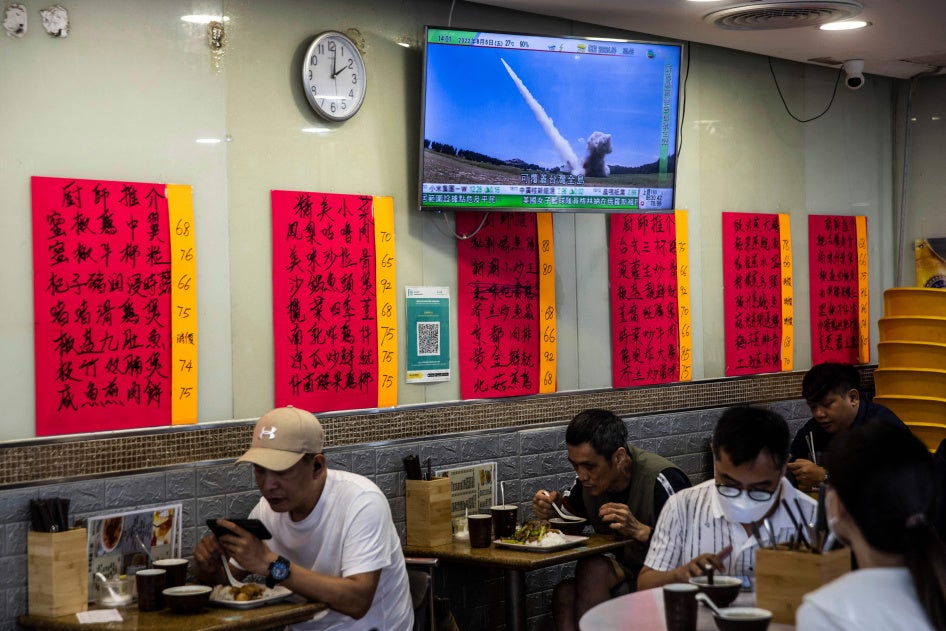 A television in a restaurant in Hong Kong shows a missile being launched during military exercises being held by China around the island of Taiwan, August 5, 2022.