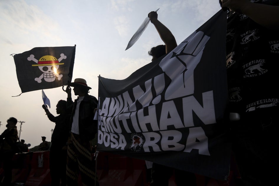 Activists wave the Straw Hat Pirates' Jolly Roger flag from the anime One Piece.