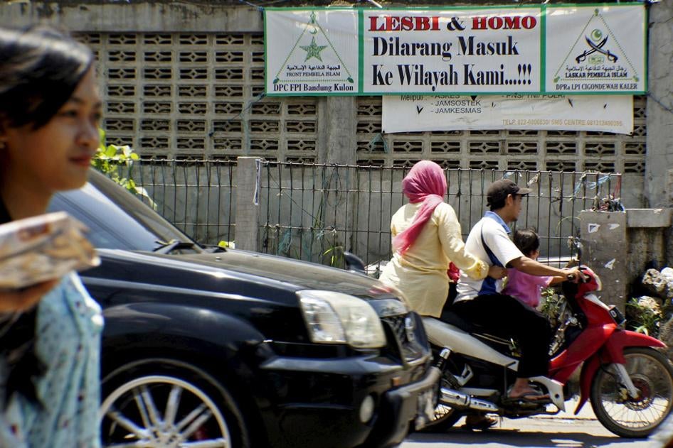 People drive a motorcycle past a banner put up by the hardline Islamic Defenders Front calling for gay people to leave the Cigondewah Kaler area in Bandung, Indonesia West Java province, January 27, 2016 in this photo taken by Antara Foto. Indonesia's thi