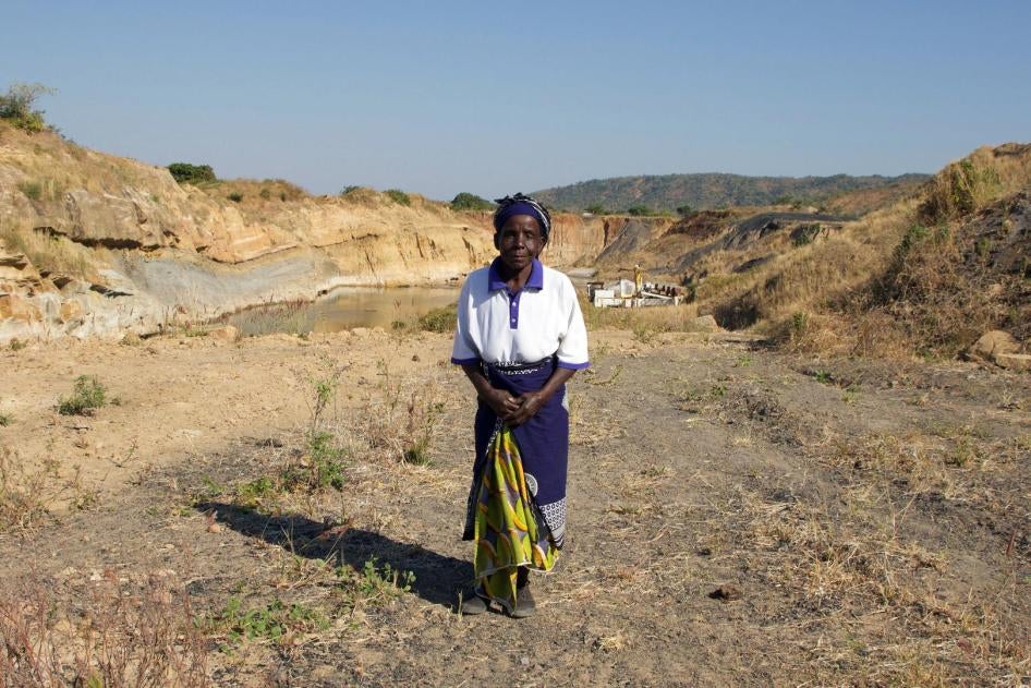 Nagomba E., 75, standing where her house used to be in Mwabulambo, Karonga district. 