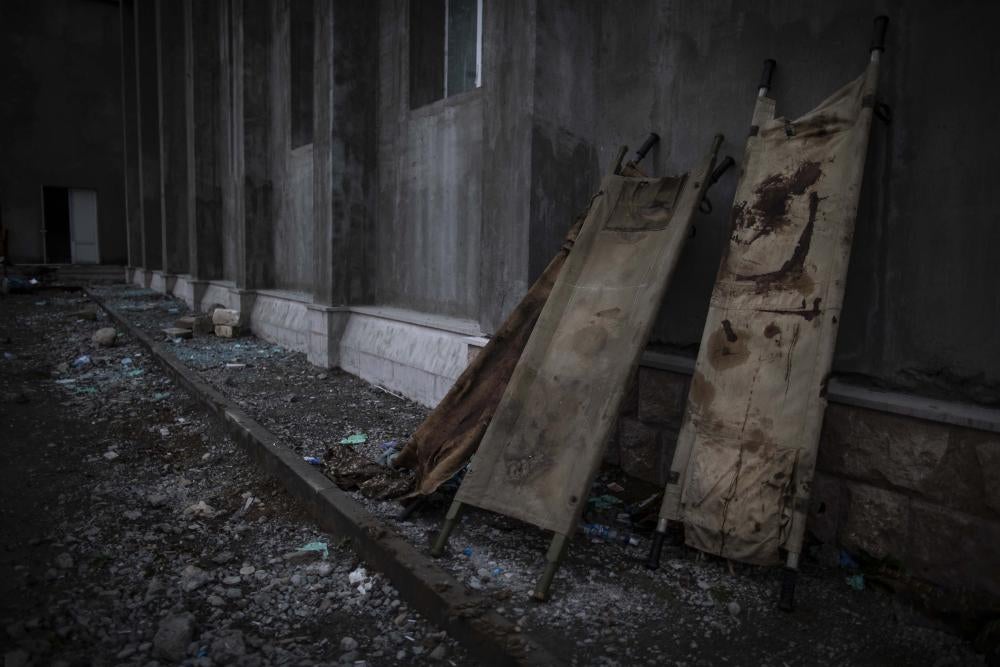 Medical stretchers propped up against a wall
