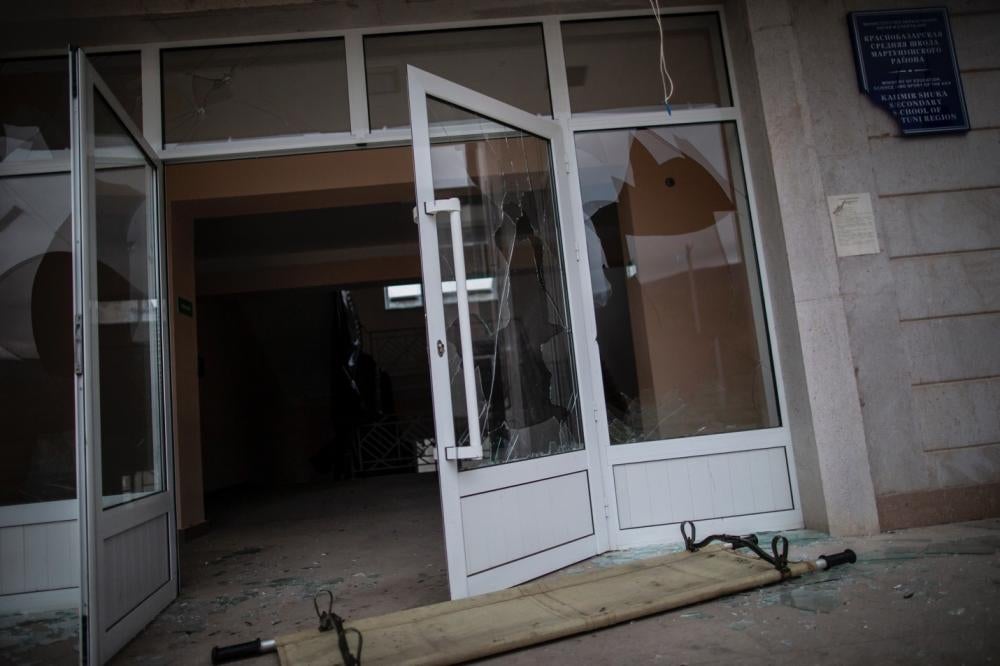 Exterior of a school building with windows blown out